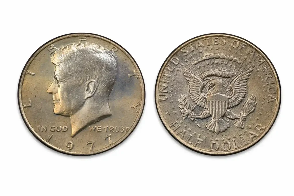Obverse and reverse of a 1977 Kennedy half dollar on a white background.